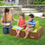 Mother attending to girl and boy sitting on 2 seat bench outdoors