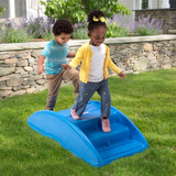 Two children climbing over the Simplay3 Rocking Bridge in the backyard