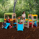 Five children playing outside on the Simplay3 Young Explorers Modular Play Set with Mom looking on