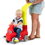 Parent pushing toddler in ride-on that can be push or foot powered