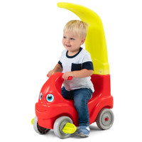 Toddler using ride-on as foot-to-floor kid powered car