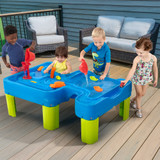 four children playing around the simplay3 big river and roads water play table