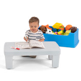 Child coloring on the Simplay3 Play Around Storage Table top