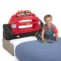 Simplay3 Monster Truck Headboard positioned on floor with boy playing